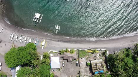 Aerial-"bird-eye"-view-of-a-beach-in-Negros-Oriental,-Philippines,-in-tropical-scenery-with-canoes