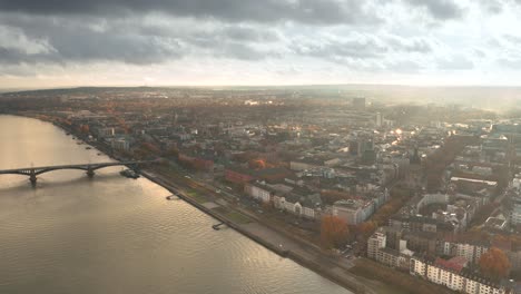 Drone-shot-of-Mainz-the-City-of-Biontech-vaccine-against-Corona-Covid-19-in-Germany-from-an-aerial-view-in-golden-fall-light-and-dramatic-sky-and-patchy-light-spots-seen-from-a-Drohne