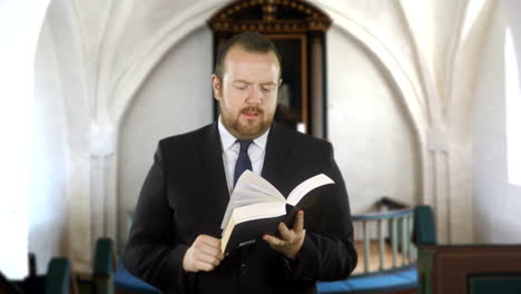 A-preacher-reads-from-the-Holy-Bible-in-church