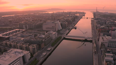 Aerial-dawn-view-of-Dublin-City,-Sunrise-in-the-Irish-capital-of-Dublin-creates-a-golden-hue-over-the-city