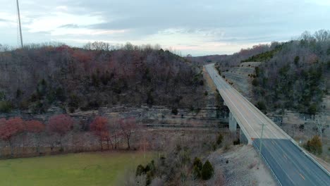 Aerial-shot-over-farm-tracking-a-vehicle-over-US-127-bridge-in-Monterey-Kentucky-beautiful-fall-scenery