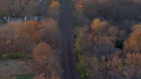 Flyover-Train-tracks-in-a-small-town-in-Autumn-at-sunset