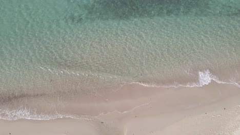 top-down-view-aerial-white-sand-beach-with-clear-ocean-water-small-waves