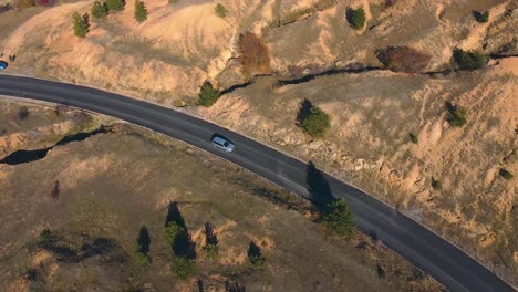 Car-driving-on-an-open-road-drone-shot