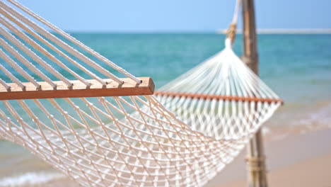 Empty-hammock-on-beach.-Focus-on-foreground