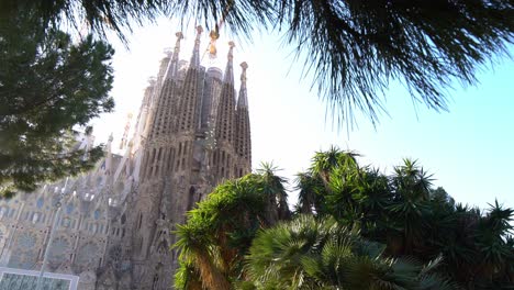 Quick-pan-down-of-La-Sagrada-Familia-from-the-park-opposite,-Barcelona