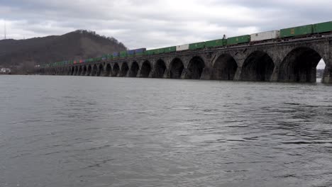 Harrisburg,-Pennsylvania---January-7,-2021:-train-crossing-a-stone-bridge-over-the-Susquehanna-River-near-Harrisburg,-Pennsylvania