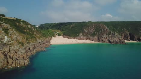 Porthcurno-Beach-and-turquoise-sea,-Cornwall-coast-in-summer,-aerial-view