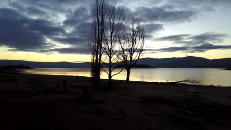 Sunset-over-the-lake-and-mountains-of-Jindabyne,-Australia--aerial