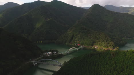 Luftaufnahme-Von-Miyama-Und-Mito-Brücke-über-Den-Okutamasee-Mit-üppigen-Grünen-Bergen-In-Okutama,-Tokio,-Japan