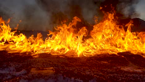 A-wall-of-fire-burns-on-the-ground-as-an-oil-spill-is-dealt-with-in-the-field