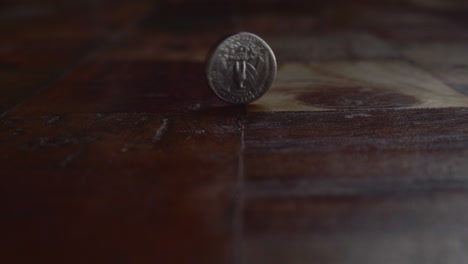 Coin-Spinning-On-Wooden-Floor-After-Flipping