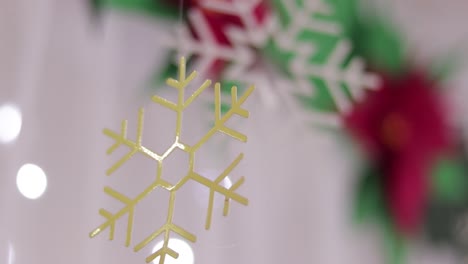 Christmas-decorations.-Poinsettias-and-metalic-snowflakes.-Blurred-background