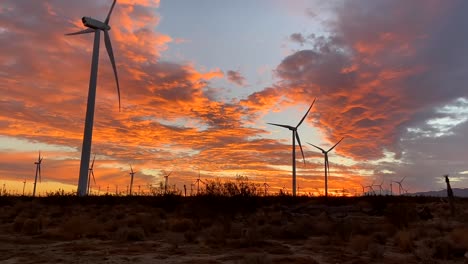 Time-lapse-of-wind-turbines,-amazing-colorful-sunset-full-of-clouds