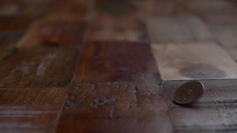 Coin-Bounces-On-The-Wooden-Floor.-close-up