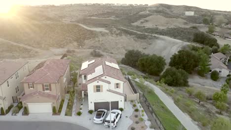 Aerial,-houses-with-solar-panels-at-sunset,-sustainable-energy,-Santa-Clarita