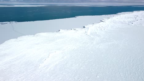 Cinematic-Aerial-Drone-across-frozen-lake-ocean-4K-global-warming-and-climate-change