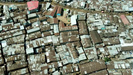 Aerial-top-down-of-destroyed-and-cheap-housing-area-of-Kibera-Slums-in-Nairobi,-Africa