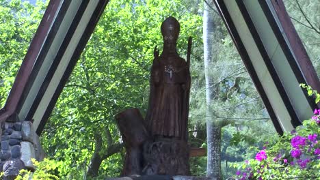 Statue-of-Monsignor-Dordillon-in-the-Gardens-of-Notre-Dame-Cathedral-in-Taiohae,-Nuku-Hiva,-French-Polynesia