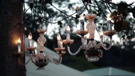Hanging-Candelabra-Outdoor-For-Wedding-Decoration-At-Sunset---low-angle-shot