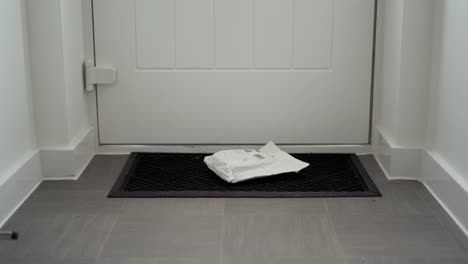 parcel-delivery-laying-on-doormat-after-being-posted-through-letterbox