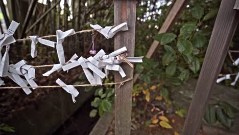 O-mikuji-Fortune-Paper-Strips-Tied-On-Rope-Fence-At-Japanese-Temple