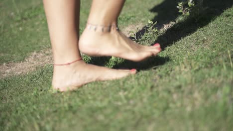 Young-female-walking-on-the-grass-close-up-steps-outdoors2-slow-motion-and-60fps