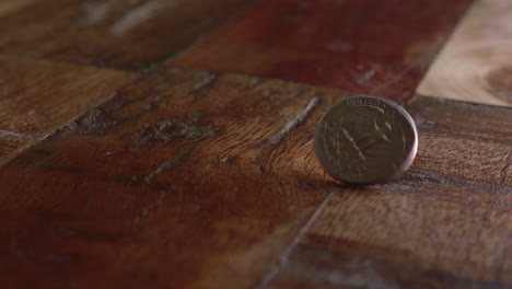Quarter-Dollar-Coin-Spins-On-The-Wooden-Floor