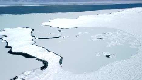Aerial-Drone-Pan-across-frozen-lake-ocean---climate-change-and-global-warming-4K