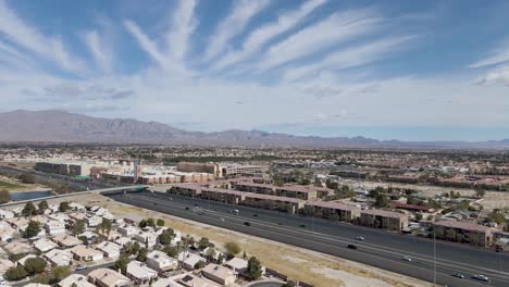 Aerial-view-of-Summerlin-Area-with-mountains-in-background-and-sky-with-striped-clouds,-Las-Vegas