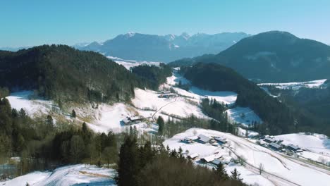4K-aerial-drone-flight-moving-above-snowy-hills-and-tree-tops-in-the-Bavarian-Alps-in-winter-in-Germany,-close-to-Austria