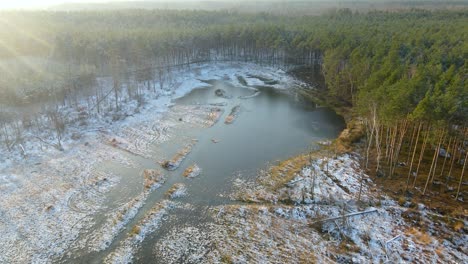 Aerial-wide-view-snow-covered-marshlands-area-in-winter