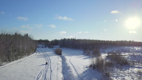 All-terrain-vehicle-driving-on-snow-in-winter-landscape