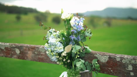 Dekoratives-Blumenarrangement-Auf-Verschwommenem-Hintergrund-Der-Wiese-Während-Der-Hochzeitszeremonie-Im-Freien