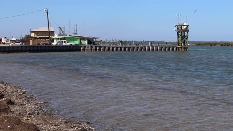 view-of-the-bait-shop,-boat-ramp-and-jetty-under-the-JFK-causeway-at-North-Padre-Island,-Texas