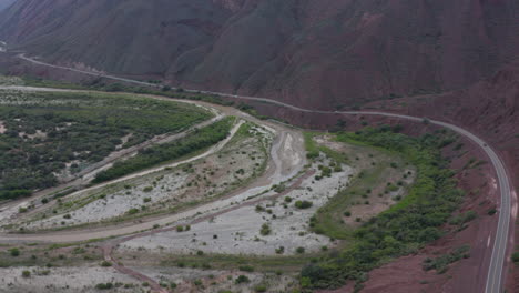 Aerial---Highway-and-mountains,-Cafayate,-Argentina,-wide-rising-shot