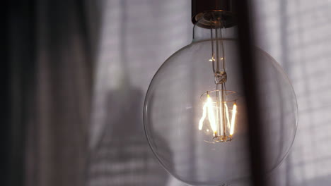 Light-bulb-showing-glowing-tungsten-filament.-Close-up