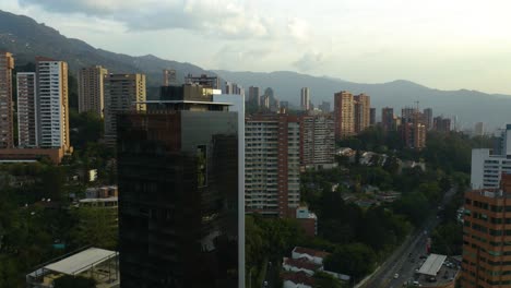 Drone-Rises-to-Reveal-El-Poblado,-Medellin,-Colombia