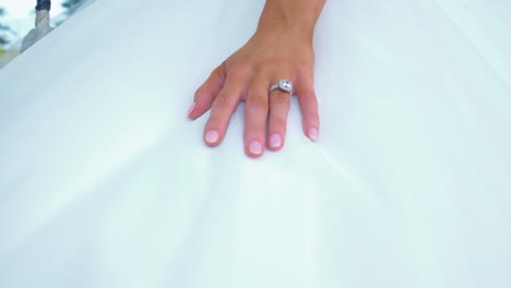 Caucasian-Bride-In-Her-Wedding-Dress-Wearing-Her-Elegant-Diamond-Ring