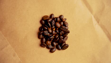 Pile-of-coffee-beans-rotates-in-a-circle-filming-from-above-vintage-look