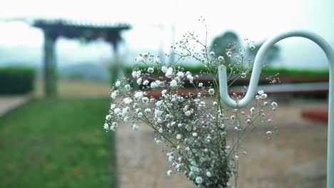 Bunch-Of-Baby's-breath-Flowers-Hang-As-A-Decoration-On-The-Aisle-Of-Outdoor-Wedding-Ceremony