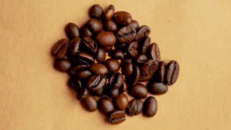 Pile-of-coffee-beans-rotates-in-a-circle-close-up-filming-from-above-vintage-look