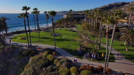 Aerial-drone-view-over-people-enjoying-themselves-at-the-Treasure-Island-Park-in-Laguna-Beach-California