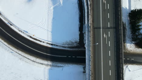 Vehicle-Drives-On-The-Road-Underneath-The-Flyover-On-A-Winter-Sunny-Day-In-Rakowice,-Krakow,-Poland