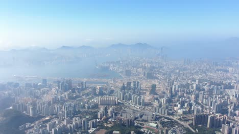 Hong-Kong-bay-and-skyline-with-skyscrapers,-high-altitude-wide-shot