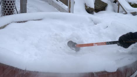Close-view-of-a-person-hammering-snow-to-break-the-ice