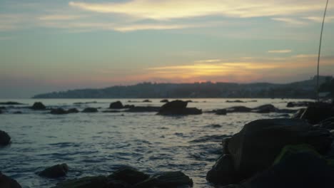 Defocused-background-at-a-rocky-beach-during-twilight