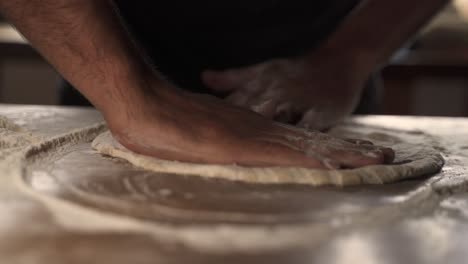 4K-Male-chef-kneading-homemade-pizza-dough-on-wooden-table-2