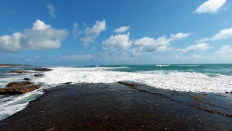 Waves-crashing-against-rocks-on-the-tropical-gorgeous-Brazilian-beach-of-Sibauma-near-Pipa-in-Rio-Grande-do-Norte,-Brazil-on-a-warm-sunny-summer-day