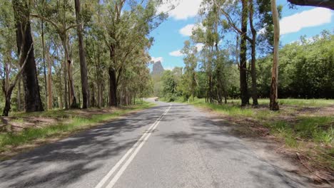 Rear-facing-driving-point-of-view-POV-of-a-deserted-Queensland-country-road-with-Glasshouse-Mt-Coonowrin---ideal-for-interior-car-scene-green-screen-replacement